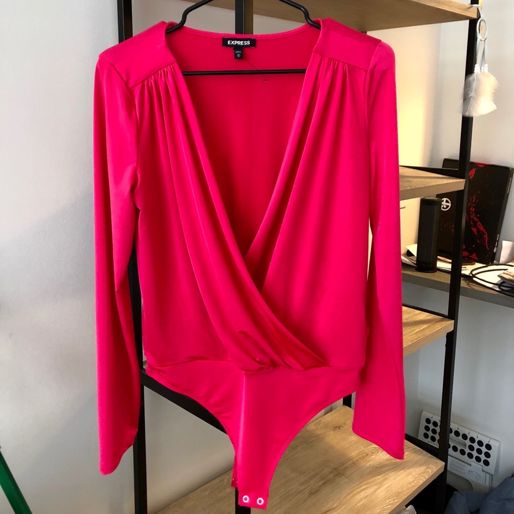 Long-sleeved bright pink bodysuit.
